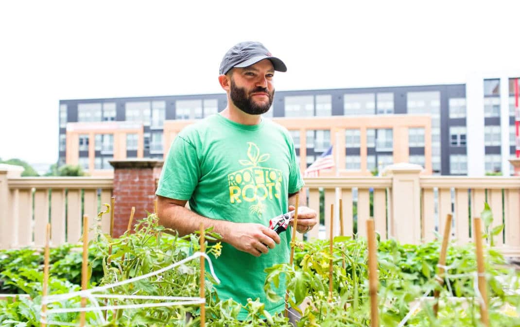 Thomas Schneider, the founder and executive director of Rooftop Roots, in one of his gardens. (Keith Lane/for The Washington Post)