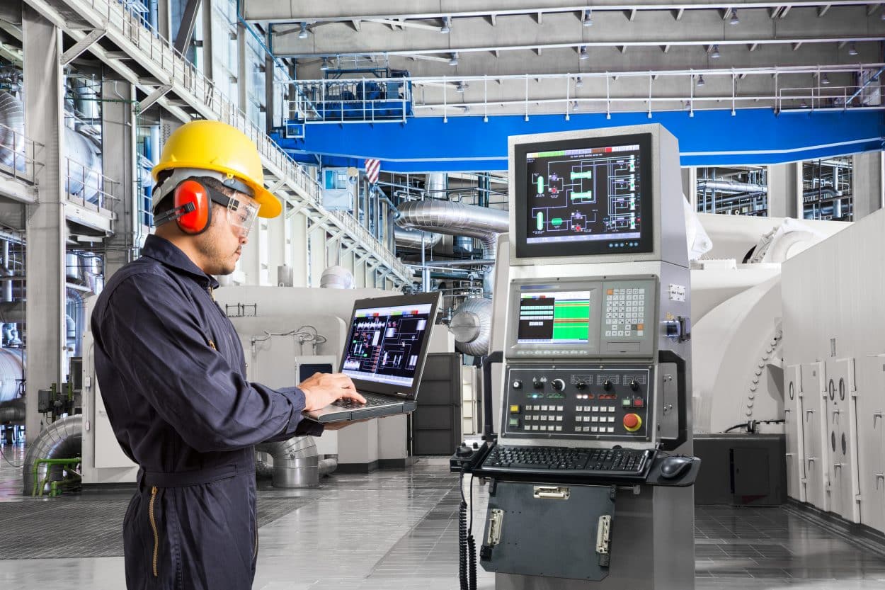 Engineer using computer for maintenance equipment in powerhouse